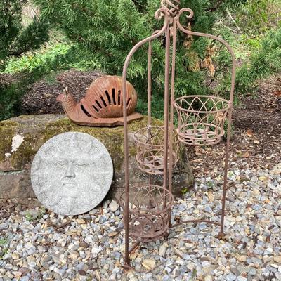 LOT 124G: Cast Iron Snail, Three Tier Folding Plant Stand and Concrete Sun Face Plaque