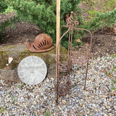 LOT 124G: Cast Iron Snail, Three Tier Folding Plant Stand and Concrete Sun Face Plaque