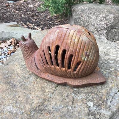 LOT 124G: Cast Iron Snail, Three Tier Folding Plant Stand and Concrete Sun Face Plaque
