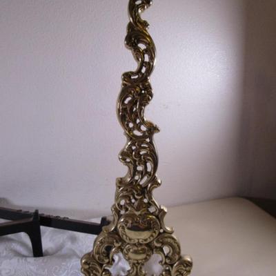 Coronet andiron or brass easel, metal support for logs in a fireplace