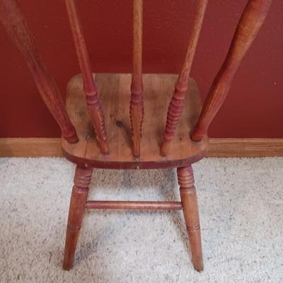 BISQUE HEAD, HANDS AND FEET ANTIQUE DOLL WITH A STURDY CHILD'S CHAIR