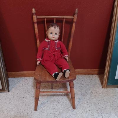 BISQUE HEAD, HANDS AND FEET ANTIQUE DOLL WITH A STURDY CHILD'S CHAIR