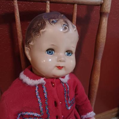 BISQUE HEAD, HANDS AND FEET ANTIQUE DOLL WITH A STURDY CHILD'S CHAIR