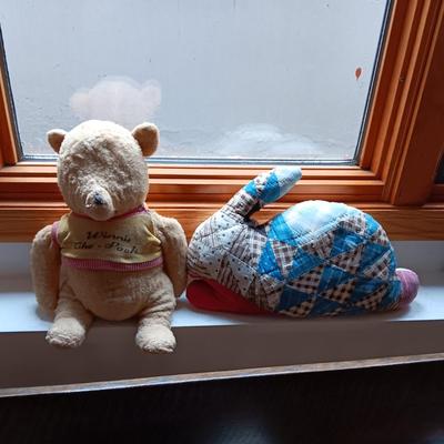 A VERY OLD AND MUCH LOVED WINNIE THE POOH PLUS A PATCHWORK RABBIT