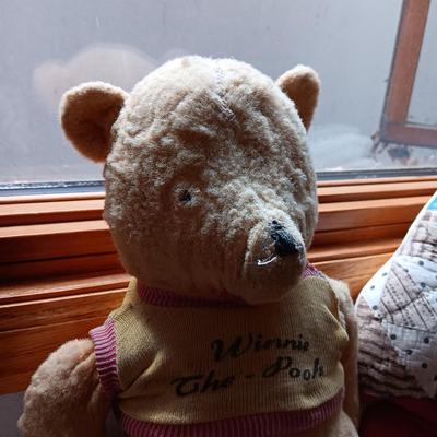 A VERY OLD AND MUCH LOVED WINNIE THE POOH PLUS A PATCHWORK RABBIT