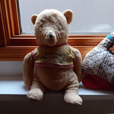 A VERY OLD AND MUCH LOVED WINNIE THE POOH PLUS A PATCHWORK RABBIT