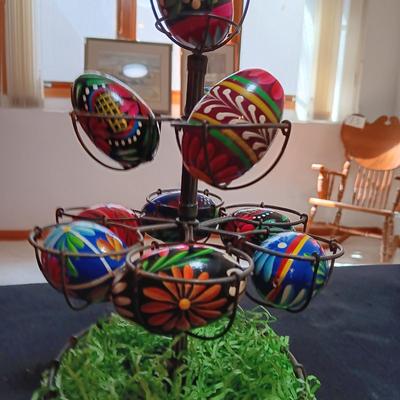 HAND PAINTED EGGS IN A METAL RACK AND A GLASS RABBIT