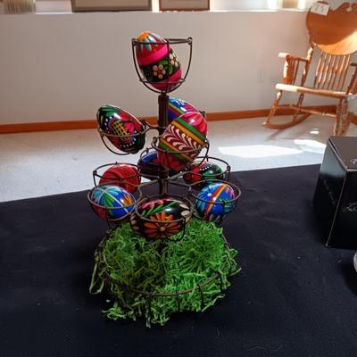 HAND PAINTED EGGS IN A METAL RACK AND A GLASS RABBIT