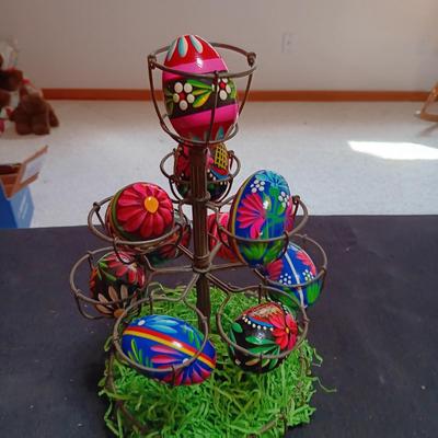 HAND PAINTED EGGS IN A METAL RACK AND A GLASS RABBIT