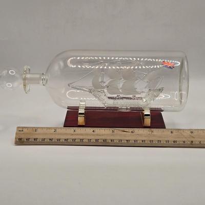 LOT 100B: Lighthouse Plate/Light, Two Ships in Bottles, and Vintage Jennings Bros. Silver Tone Sailboat Paperweight