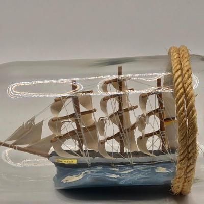 LOT 100B: Lighthouse Plate/Light, Two Ships in Bottles, and Vintage Jennings Bros. Silver Tone Sailboat Paperweight