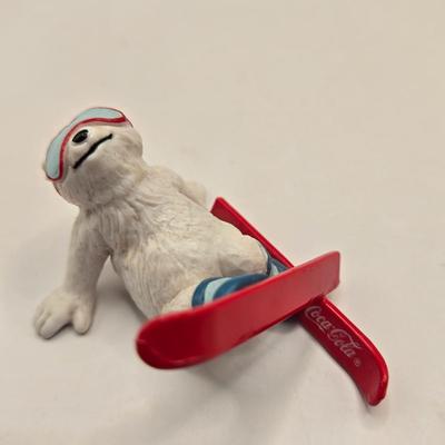 LOT 133K: Plastic Santa, Green Wooden Santa, Set of Coke-a-Cola Bears, Small Plastic Santas Playing Instruments, Clip on Holly Earrings,...