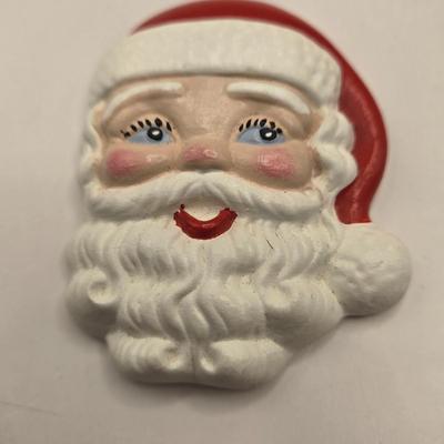 LOT 133K: Plastic Santa, Green Wooden Santa, Set of Coke-a-Cola Bears, Small Plastic Santas Playing Instruments, Clip on Holly Earrings,...