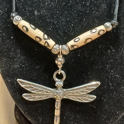 Dragonfly necklace, Glass box locket, blown glass mushroom pendant, and a Moose on a stone pendant