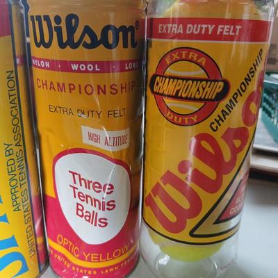 Four unopened cans of tennis balls - Spalding and Wilson - two cans are metal