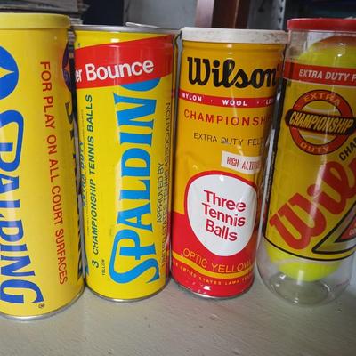 Four unopened cans of tennis balls - Spalding and Wilson - two cans are metal