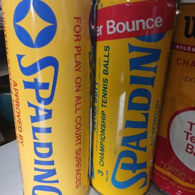 Four unopened cans of tennis balls - Spalding and Wilson - two cans are metal