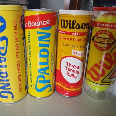 Four unopened cans of tennis balls - Spalding and Wilson - two cans are metal