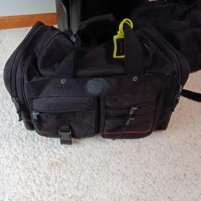 HARD SIDED AMERICAN TOURISTER SUITCASE ON 2 WHEELS AND 2 LAKORUS SOFT BAGS