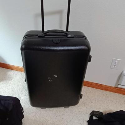 HARD SIDED AMERICAN TOURISTER SUITCASE ON 2 WHEELS AND 2 LAKORUS SOFT BAGS