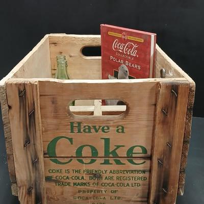 Vintage 1976 wooden Coca Cola crate with coca cola bottles, antique opener and a collectable book