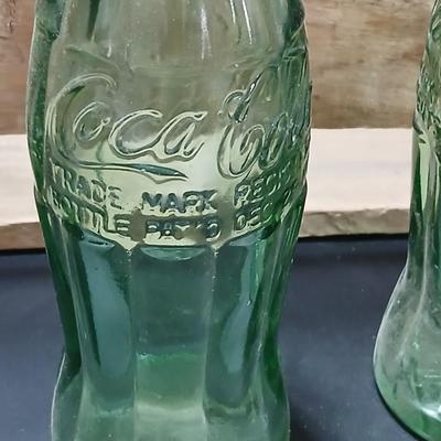 Vintage 1976 wooden Coca Cola crate with coca cola bottles, antique opener and a collectable book