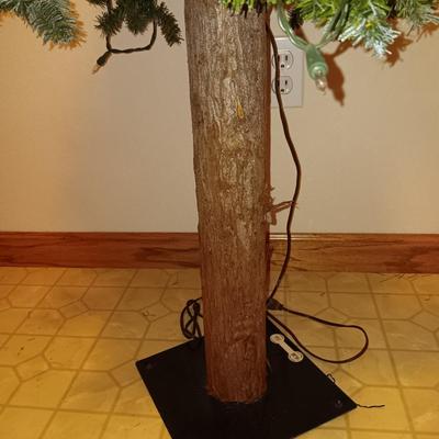 VERY NICE WREATH, GARLAND AND A FAUX LIGHTED TREE WITH LIFE LIKE TRUNK