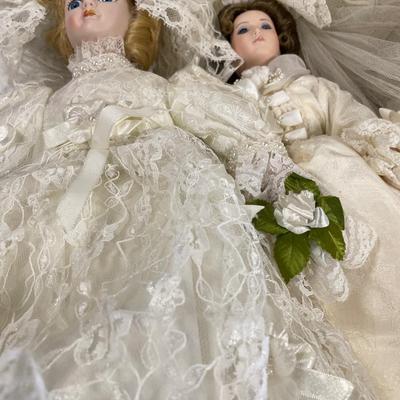 8 porcelain dolls dressed in cream