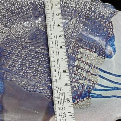 Two purple pottery dishes with signatures on the backs