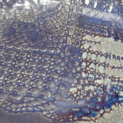 Two purple pottery dishes with signatures on the backs