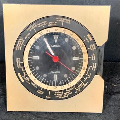 LOT 43: Collection Nautical Instruments Including a Seth Thomas Brass Ships Clock, Brass Ship’s Wheel Barometer and Lorus Quartz World...