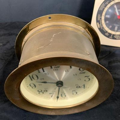 LOT 43: Collection Nautical Instruments Including a Seth Thomas Brass Ships Clock, Brass Ship’s Wheel Barometer and Lorus Quartz World...