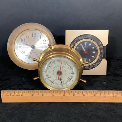 LOT 43: Collection Nautical Instruments Including a Seth Thomas Brass Ships Clock, Brass Ship’s Wheel Barometer and Lorus Quartz World...