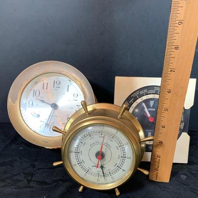 LOT 43: Collection Nautical Instruments Including a Seth Thomas Brass Ships Clock, Brass Ship’s Wheel Barometer and Lorus Quartz World...