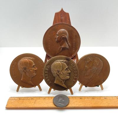 LOT 111: Five Bronze Presidential Medals / Tokens - George Washington with Wooden Stand and Three Abraham Lincoln and More