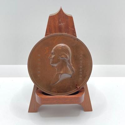 LOT 111: Five Bronze Presidential Medals / Tokens - George Washington with Wooden Stand and Three Abraham Lincoln and More
