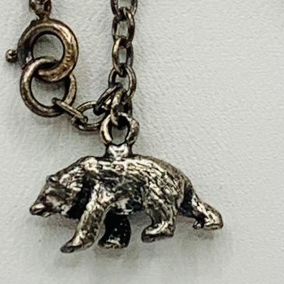 LOT 153: Sterling Silver 7” Charm Bracelet with Bear Charm and Pair of Pierced Battle Axe Earrings Marked 925 11.1 G