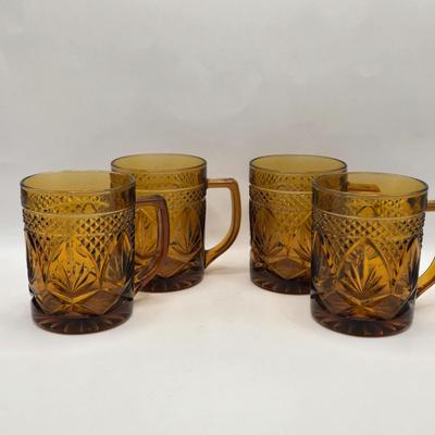 LOT 212D: Multiple Pieces of Colorful Glass Including Amber Plates, Amber Cups Made in France, 3 Pieces of Blue Glass, Candy Dish with...