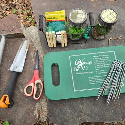 Gardening items - Vegetable seeds in a wire basket - Knee pad - Jars with gardening items - Garden knife - Hand rake and more