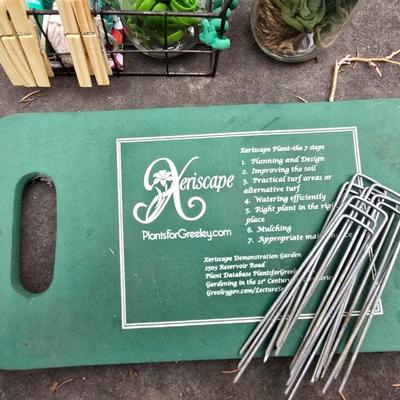 Gardening items - Vegetable seeds in a wire basket - Knee pad - Jars with gardening items - Garden knife - Hand rake and more