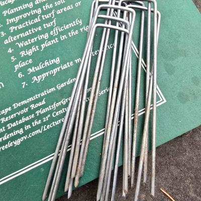 Gardening items - Vegetable seeds in a wire basket - Knee pad - Jars with gardening items - Garden knife - Hand rake and more