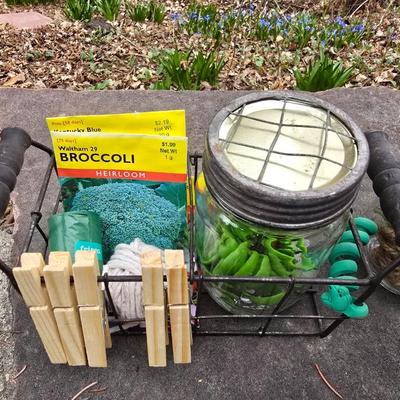 Gardening items - Vegetable seeds in a wire basket - Knee pad - Jars with gardening items - Garden knife - Hand rake and more