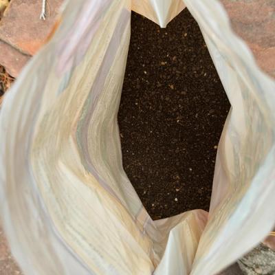 Garden pot with stand - partial bag of rose food - crafting moss - and a unopened bag of Odla hydroponic clay beads