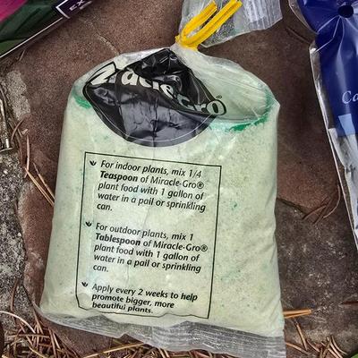 Garden pot with stand - partial bag of rose food - crafting moss - and a unopened bag of Odla hydroponic clay beads