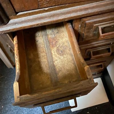 Antique storage cabinet with card catalog drawers