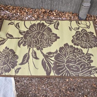 Shade sail and a smaller sized outdoor reversible area rug 57" x 35.5