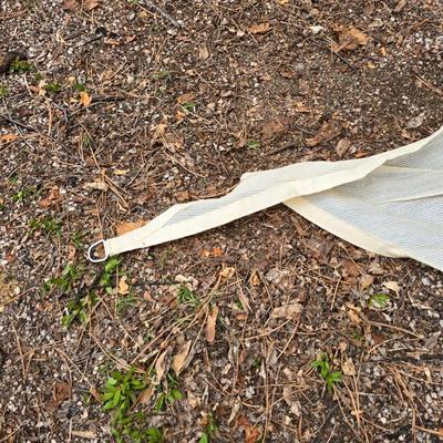 Shade sail and a smaller sized outdoor reversible area rug 57" x 35.5