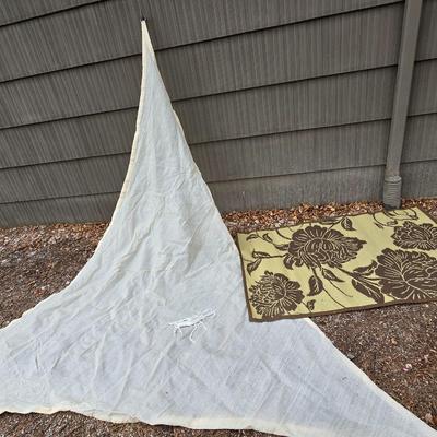 Shade sail and a smaller sized outdoor reversible area rug 57" x 35.5