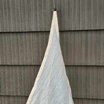 Shade sail and a smaller sized outdoor reversible area rug 57" x 35.5