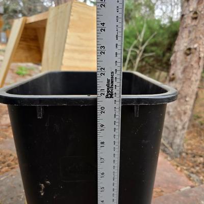 Wooden sawhorse, a blue tarp, Irwin clamp, and a trashcan
